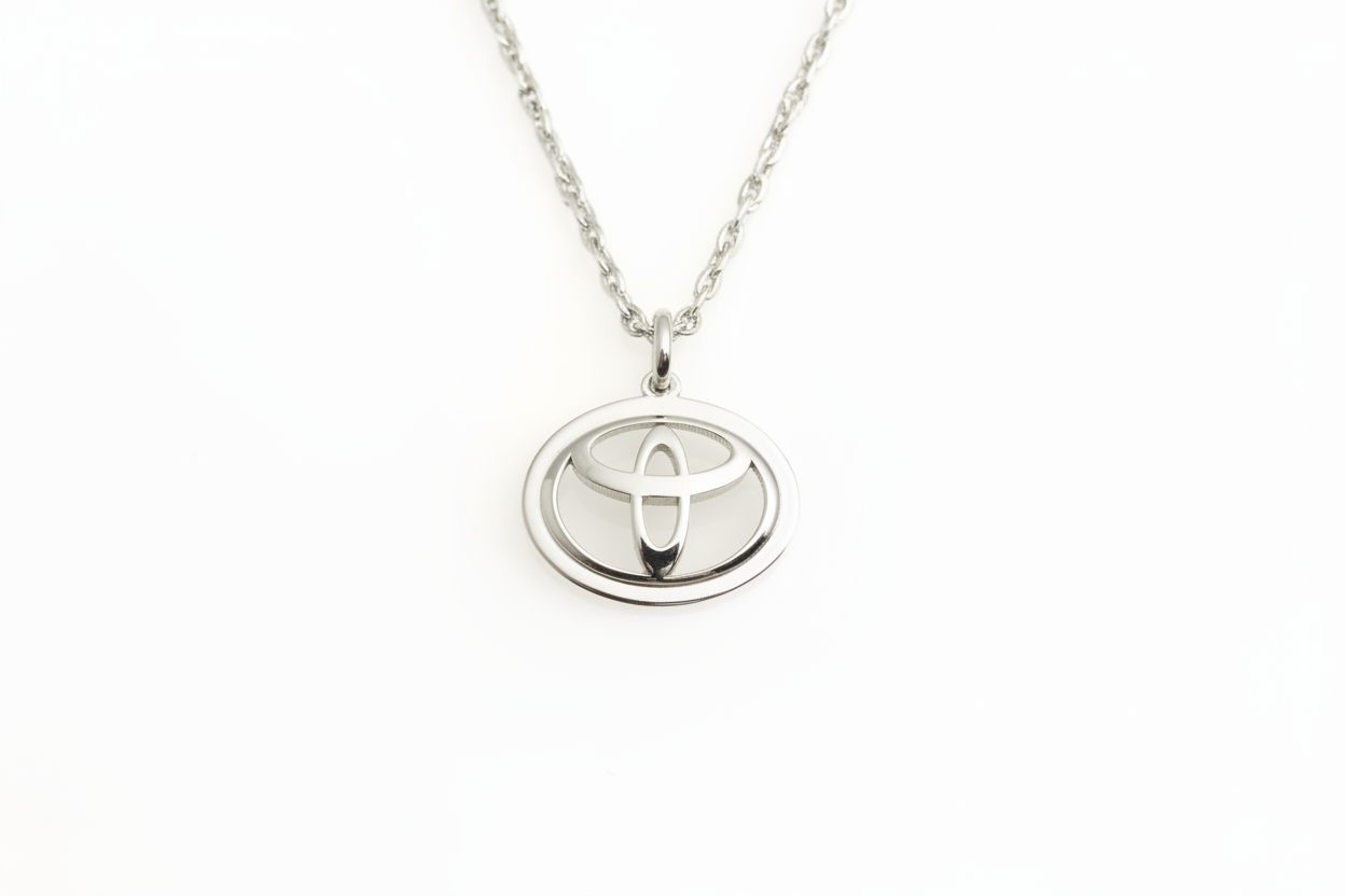 Close-up of the polished Toyota emblem pendant necklace in 925 sterling silver.